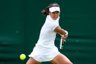 Na Li of China plays a backhand during her Ladies' Singles first round match against Michaella Krajicek of Netherlands on day two of the Wimbledon Lawn Tennis Championships at the All England Lawn Tennis and Croquet Club on June 25, 2013 in London, England. (Photo by Mike Hewitt/Getty Images)